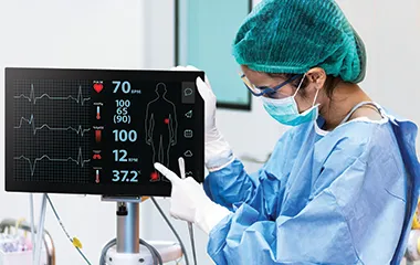 Doctor or nurse looking at a ViewSonic monitor to review patient's vitals in an operating room