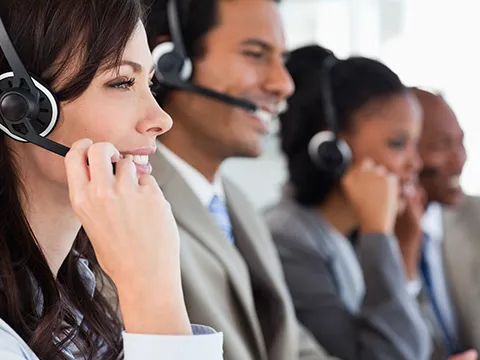 a row of people in business attire talking on headsets
