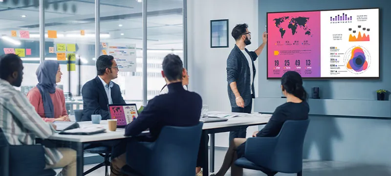 a man giving a presentation on a digital display