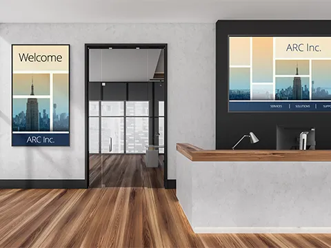 a reception desk with large format screens on the walls