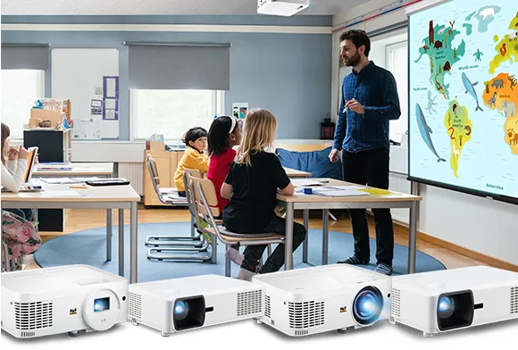 a teacher in front of a classroom with a projected image of a map of the world behind him
