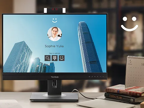 a windows login screen is shown on monitor with built-in webcam
