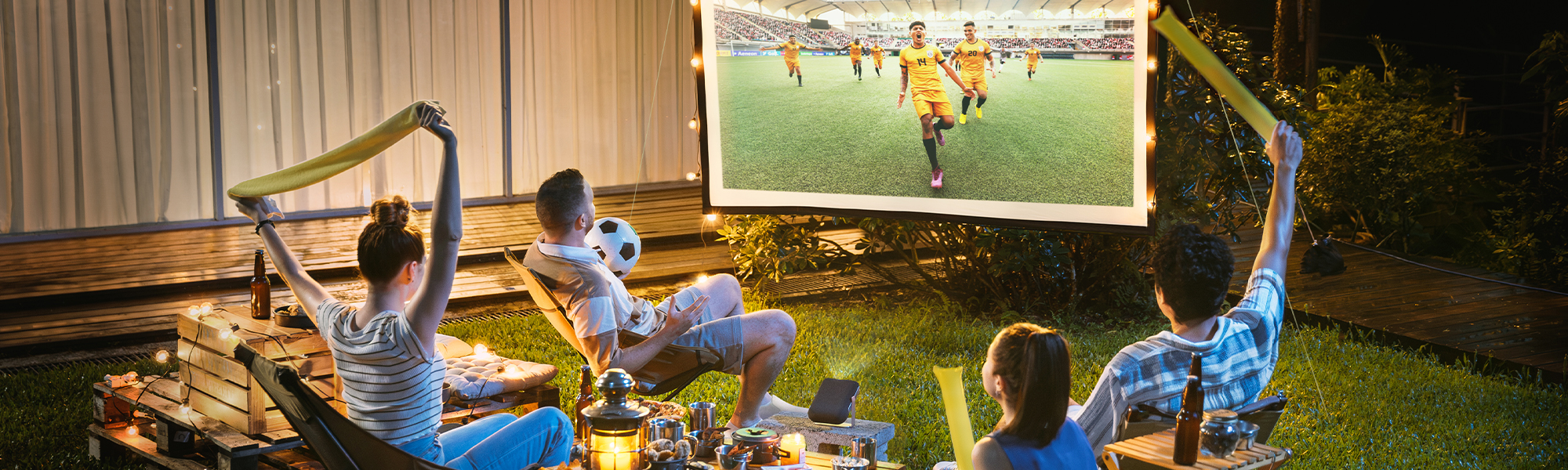 people watching a sports game on a projector outside
