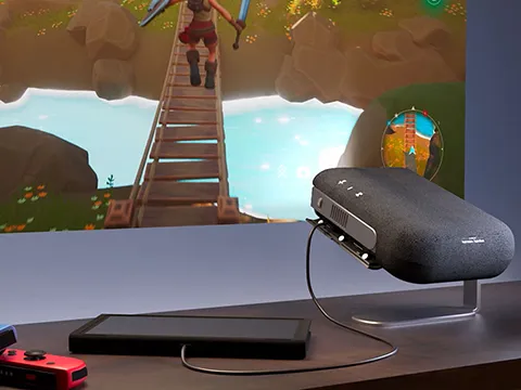 a portable projector plugged in to a nintendo switch