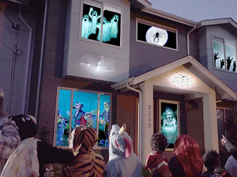 halloween projections in the window of a home