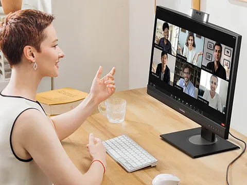 a woman on a video call with her coworkers