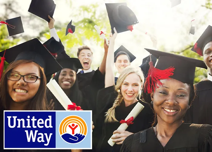 recent graduates celebrating by throwing their caps in the air