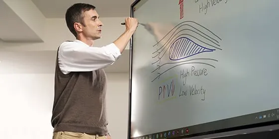 man diagraming and drawing aerodynamic illustrations on a ViewBoard