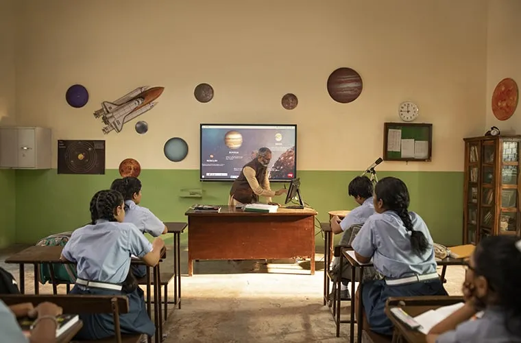 Science teacher using a viewboard in front of her class teaching astronomy