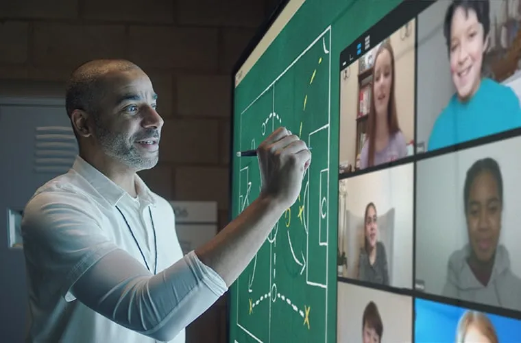 Man working on Viewboard engaging with students