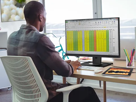 Man st desk working on a spreadsheet