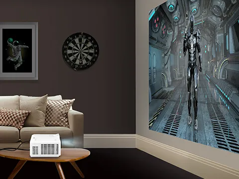 projector sitting on table throwing large gaming image on the wall